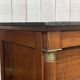 Empire bedside table from the 19th century in cherry wood and black marble.