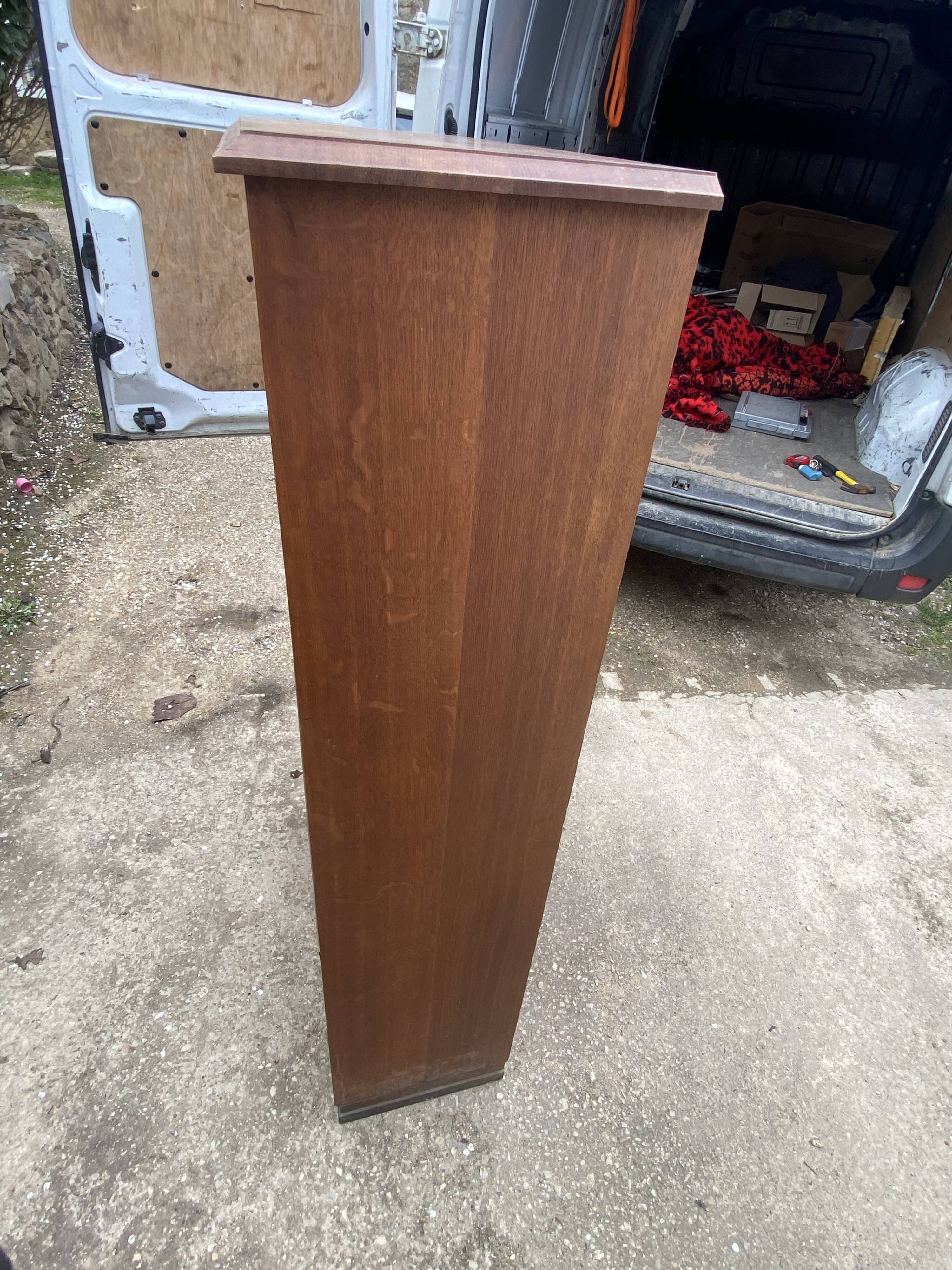 Oak two-column filing cabinet with curtains.