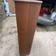 Oak two-column filing cabinet with curtains.
