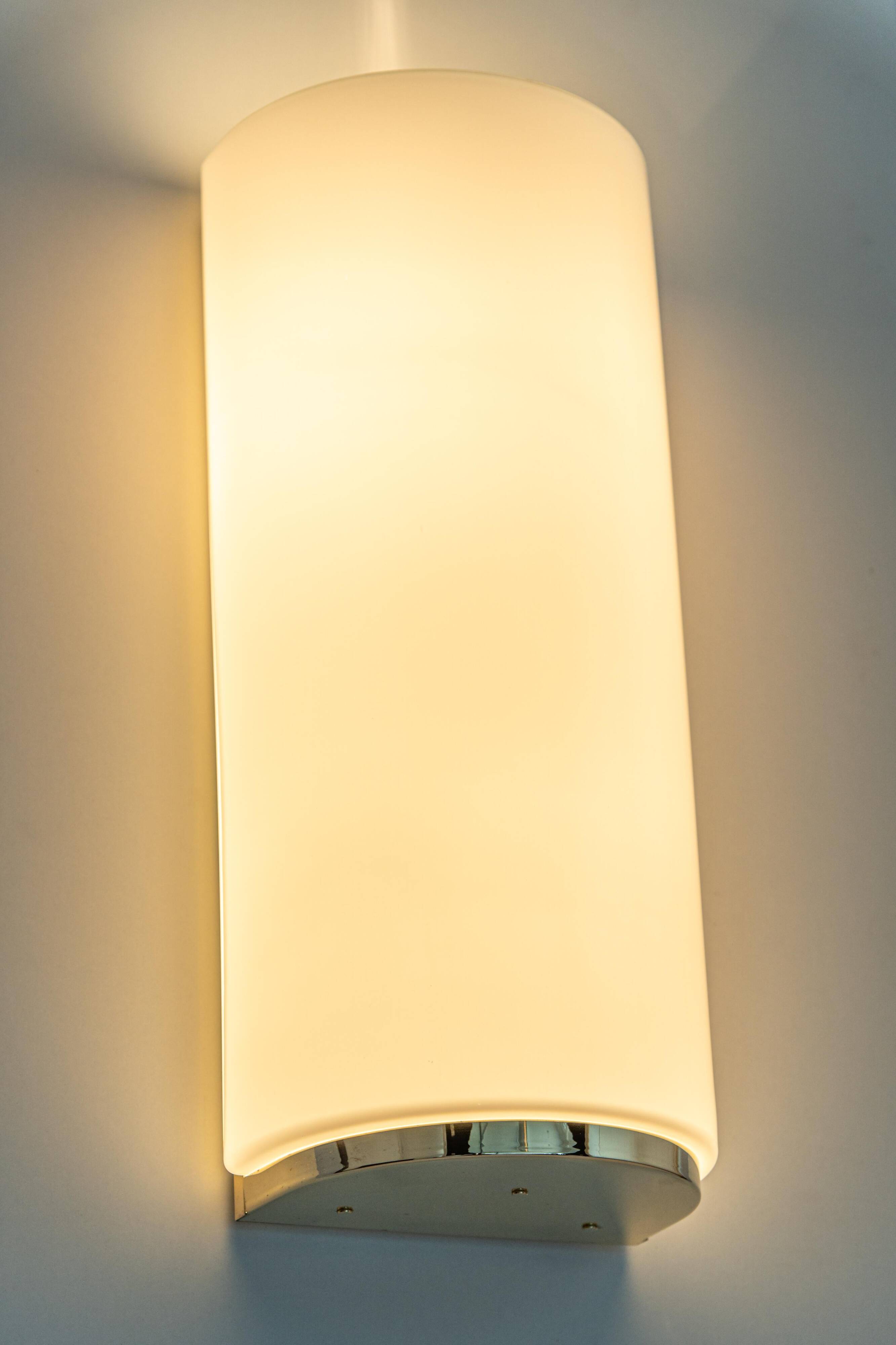 Pair of large opaline glass wall lights in brass designed by Limburg, Germany.