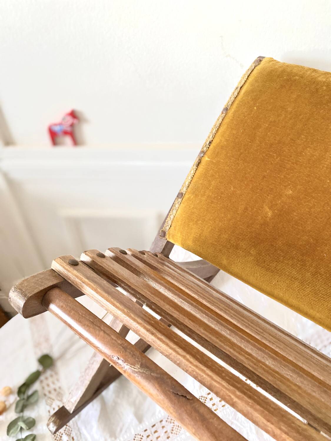 Old wooden rocking footrest with velvet fabric