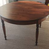 Round pine table with three extensions.
