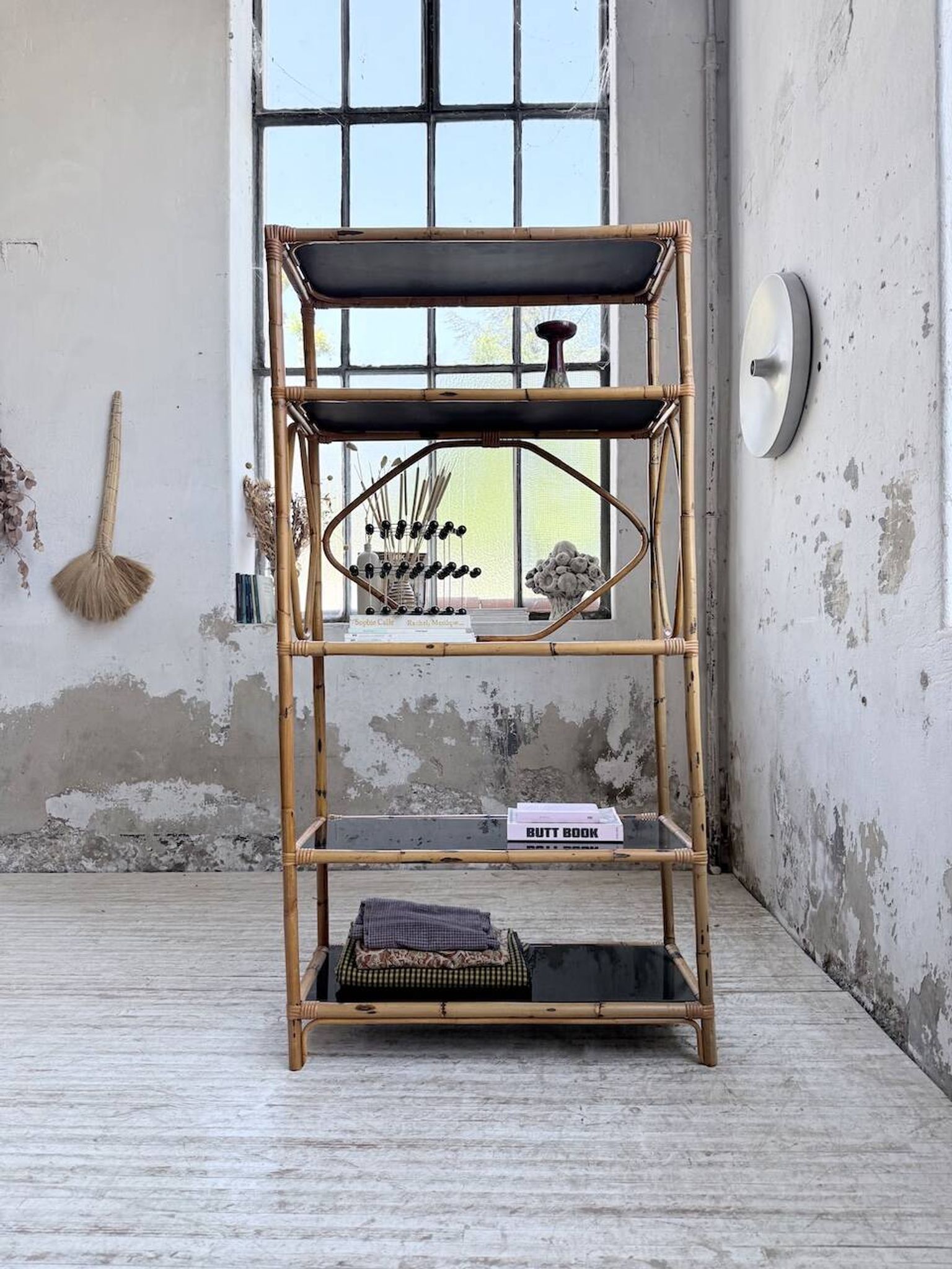 Rattan bookshelf and black glasses