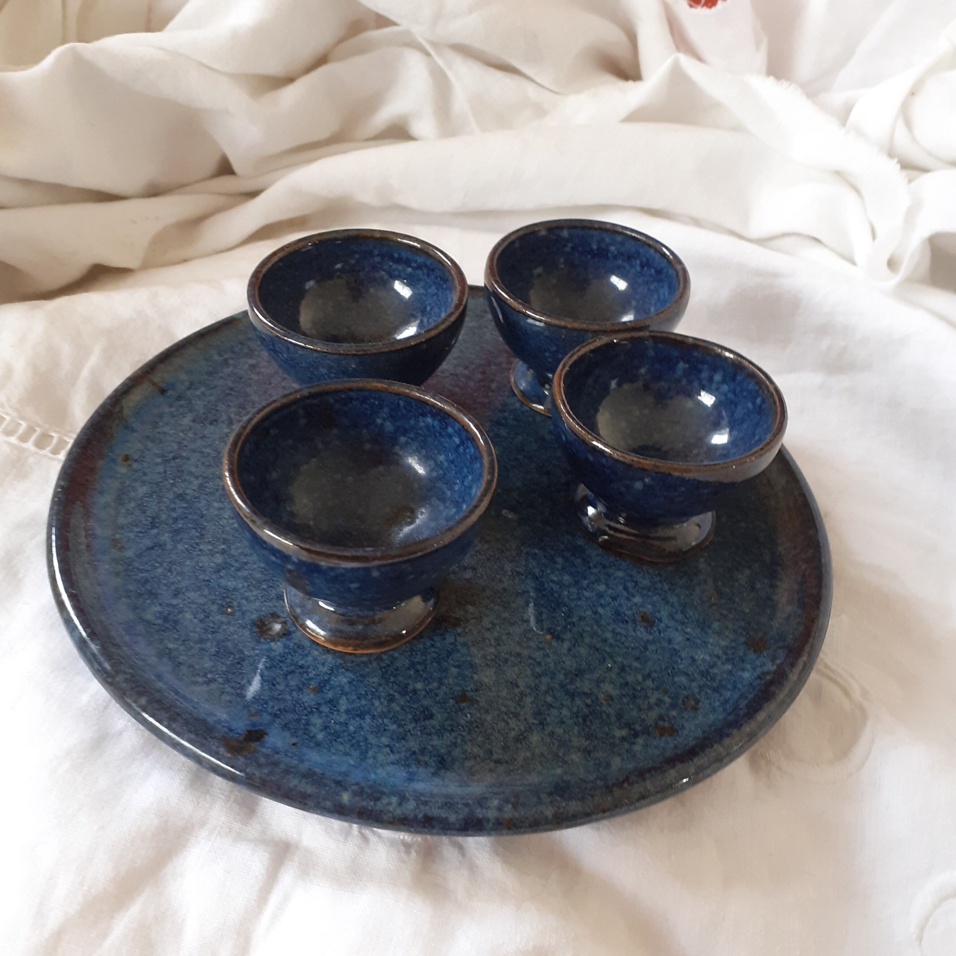 4 coquetiers on their midnight blue sandstone plate.
