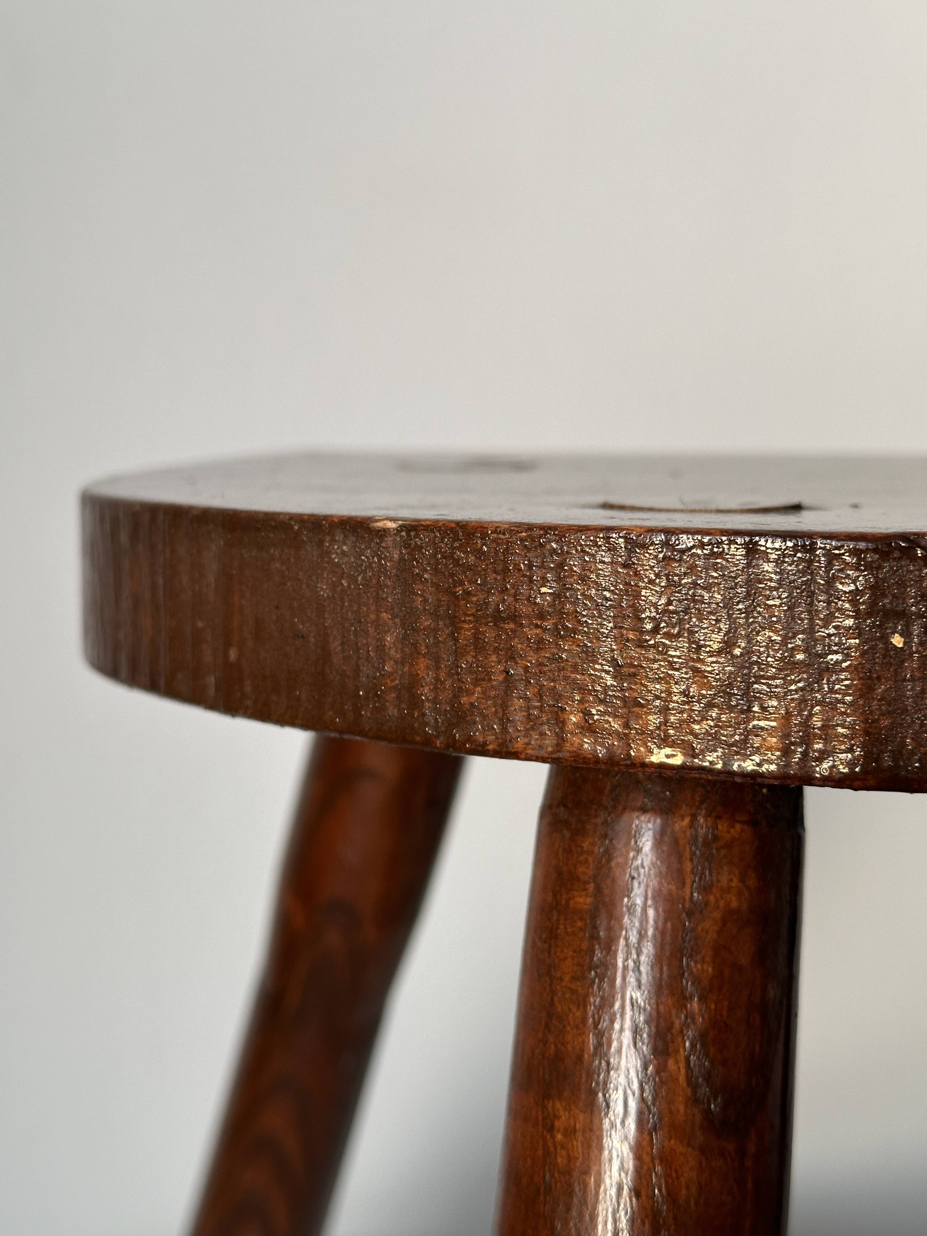 Varnished wooden stool with three legs