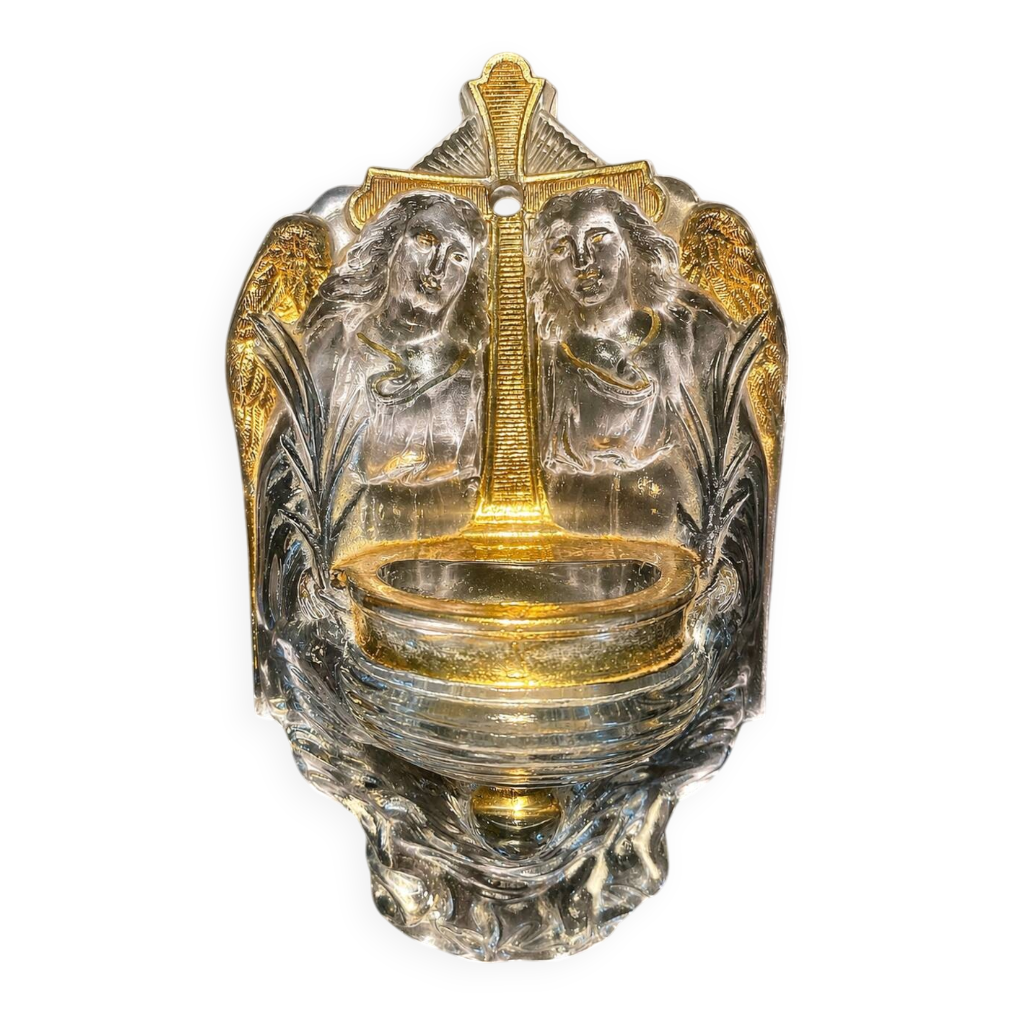 Old wall-mounted holy water font in moulded glass decorated with angels.