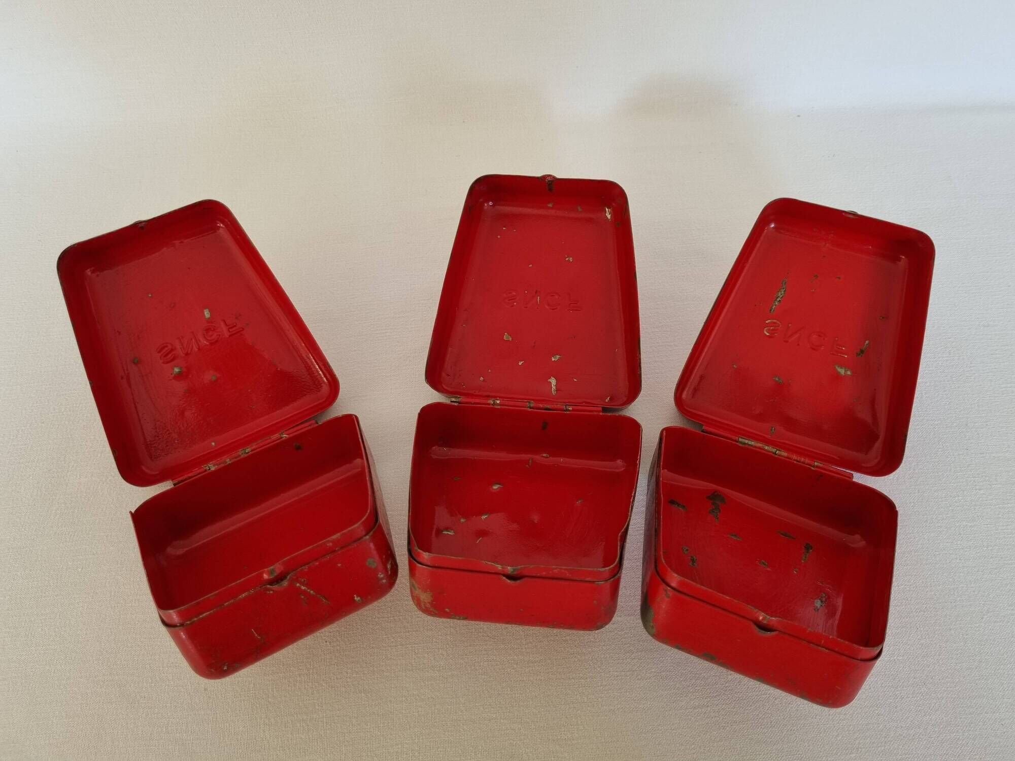 Set of three red painted metal railway boxes with SNCF logo
