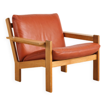 Brutalist armchair in oak and leather by Tage Poulsen, Denmark, 1970s.