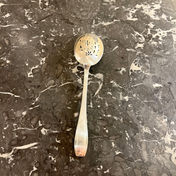 Openwork serving spoon, silver metal