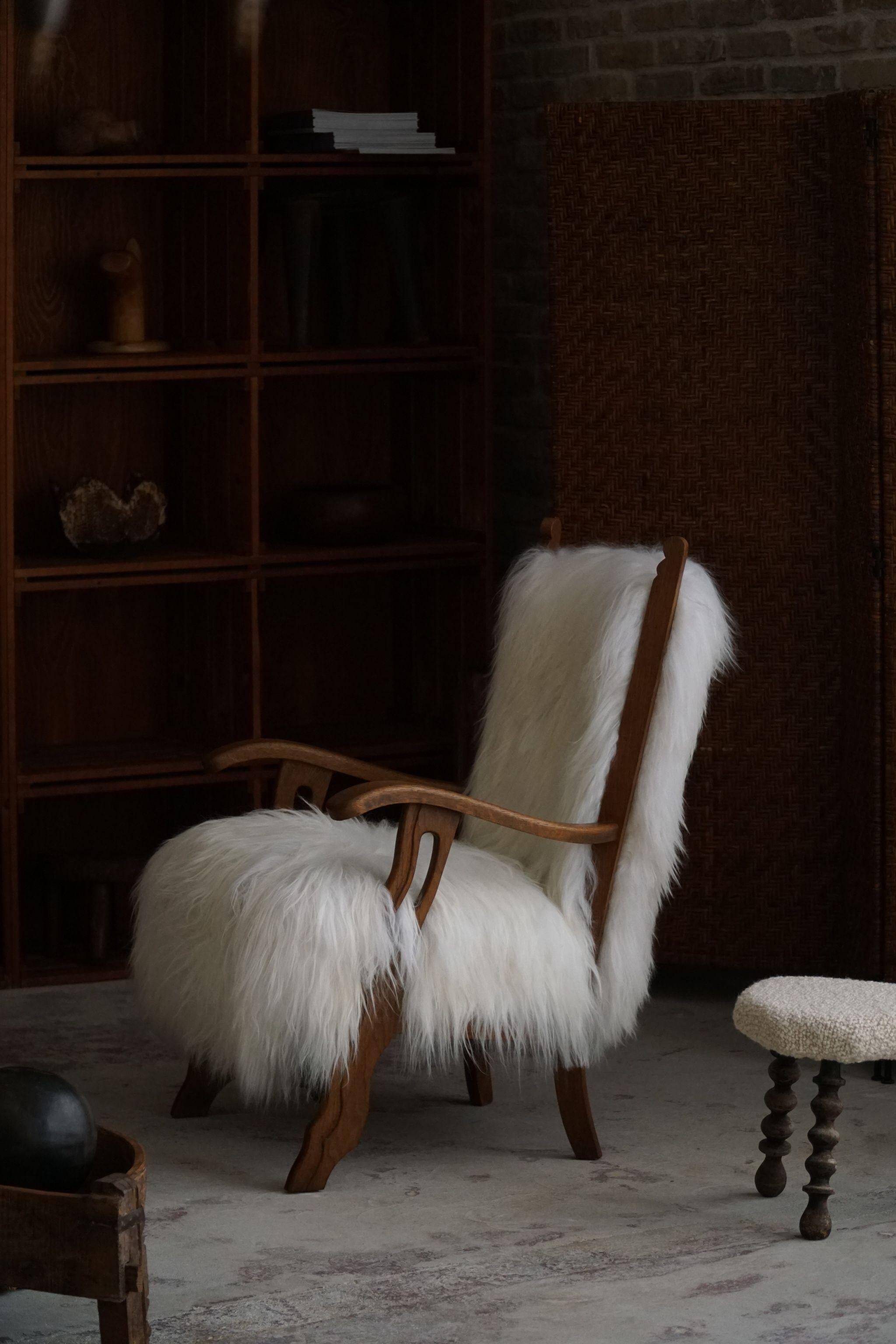 Pair of Scandinavian armchairs in oak and long-haired Icelandic sheepskin by Henning Kjærnulf, 1950.