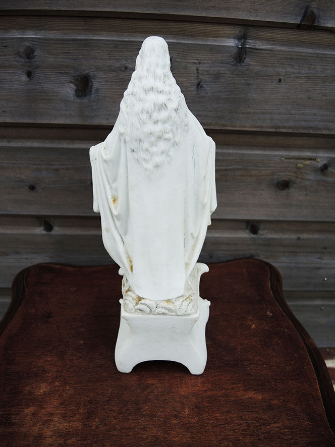 Ancient statuette of the virgin with the serpent in biscuit