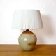 Large stone lamp with a cotton shade.