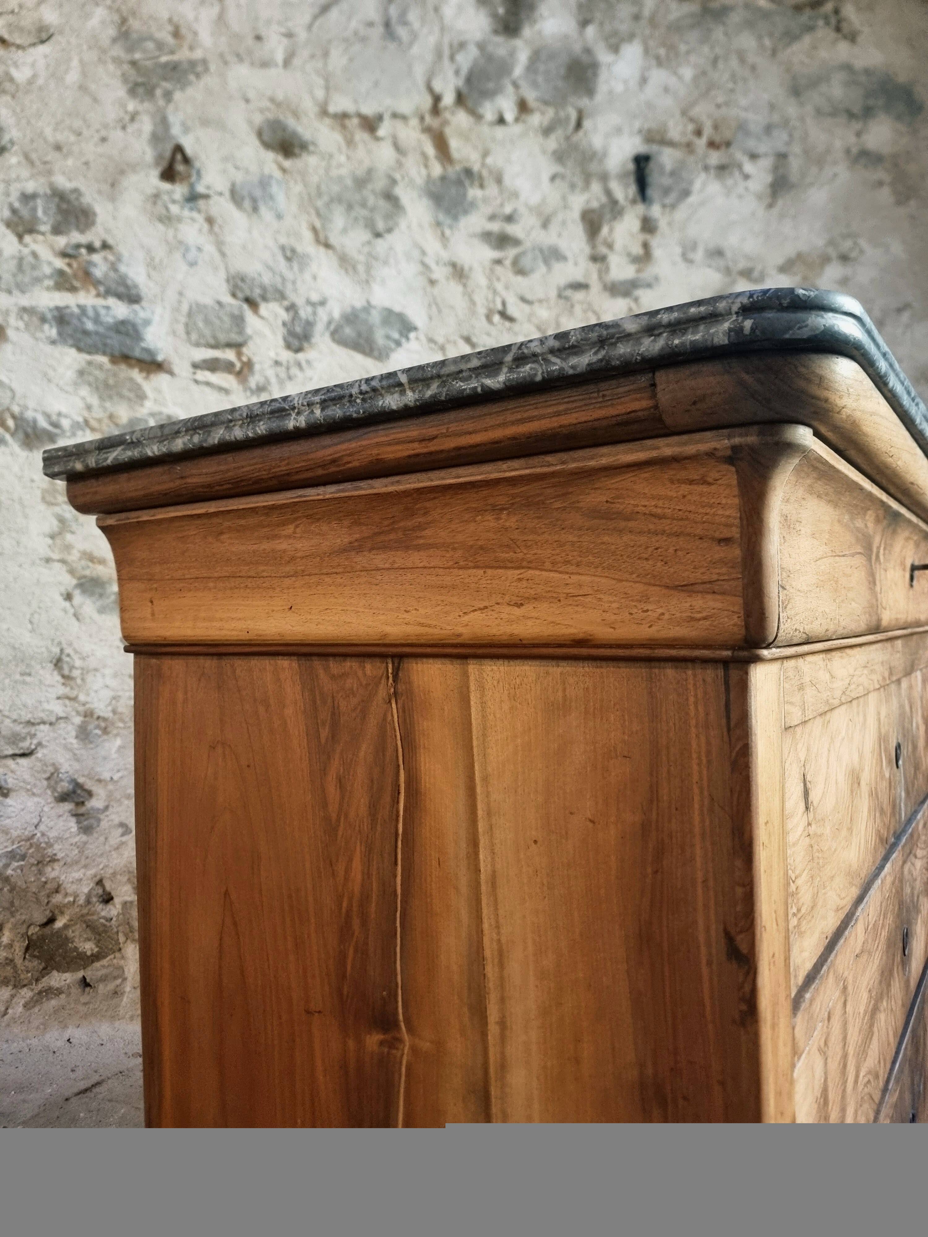 French antique walnut commode with a dark grey marble top, circa 1830–1860.