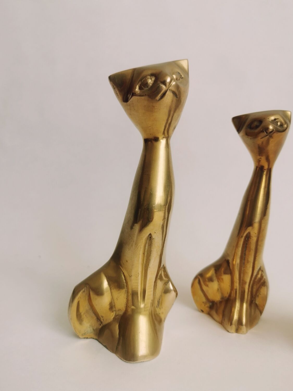 Trio of cats in gilded brass