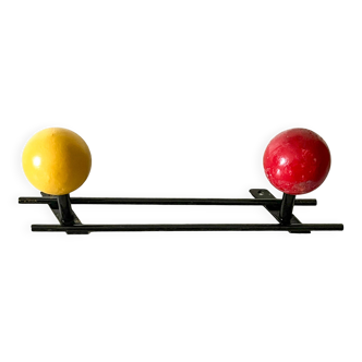 Vintage wall coat rack, metal and wood in yellow and red.