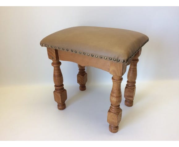 Rustic tabouret on leather