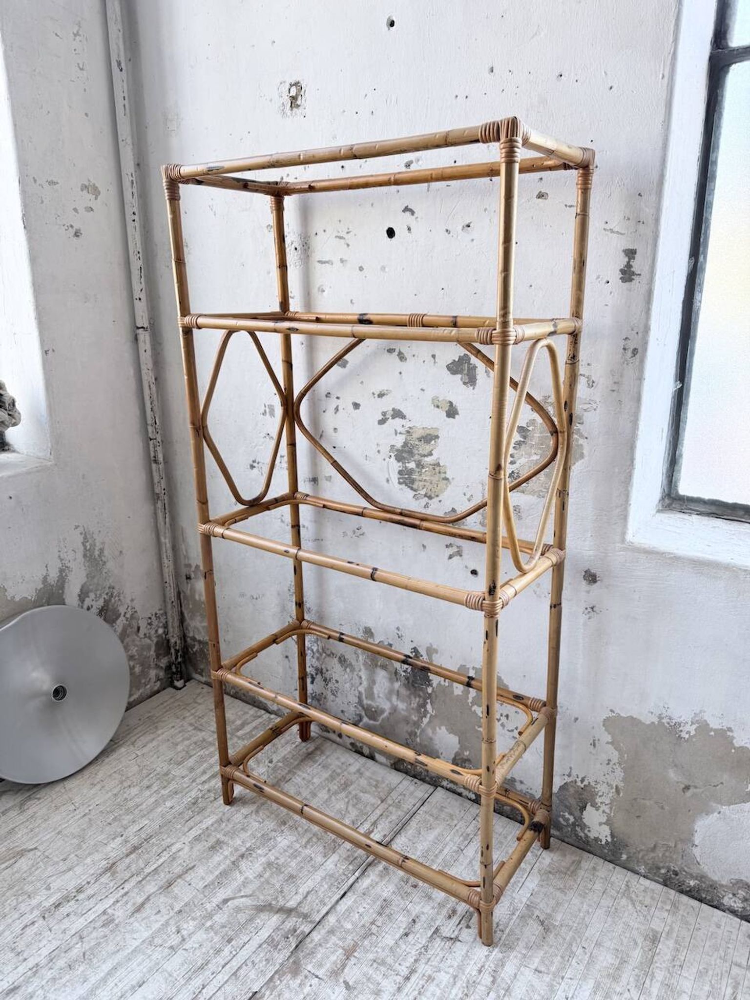 Rattan bookshelf and black glasses