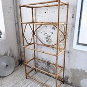 Rattan bookshelf and black glasses
