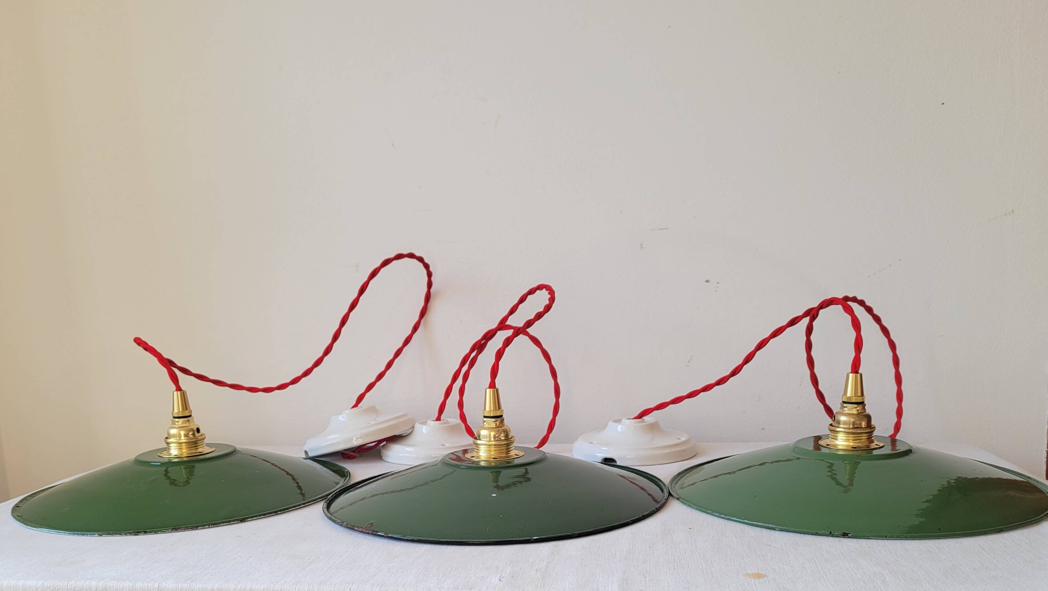 Trio of enameled sheet metal pendant lights