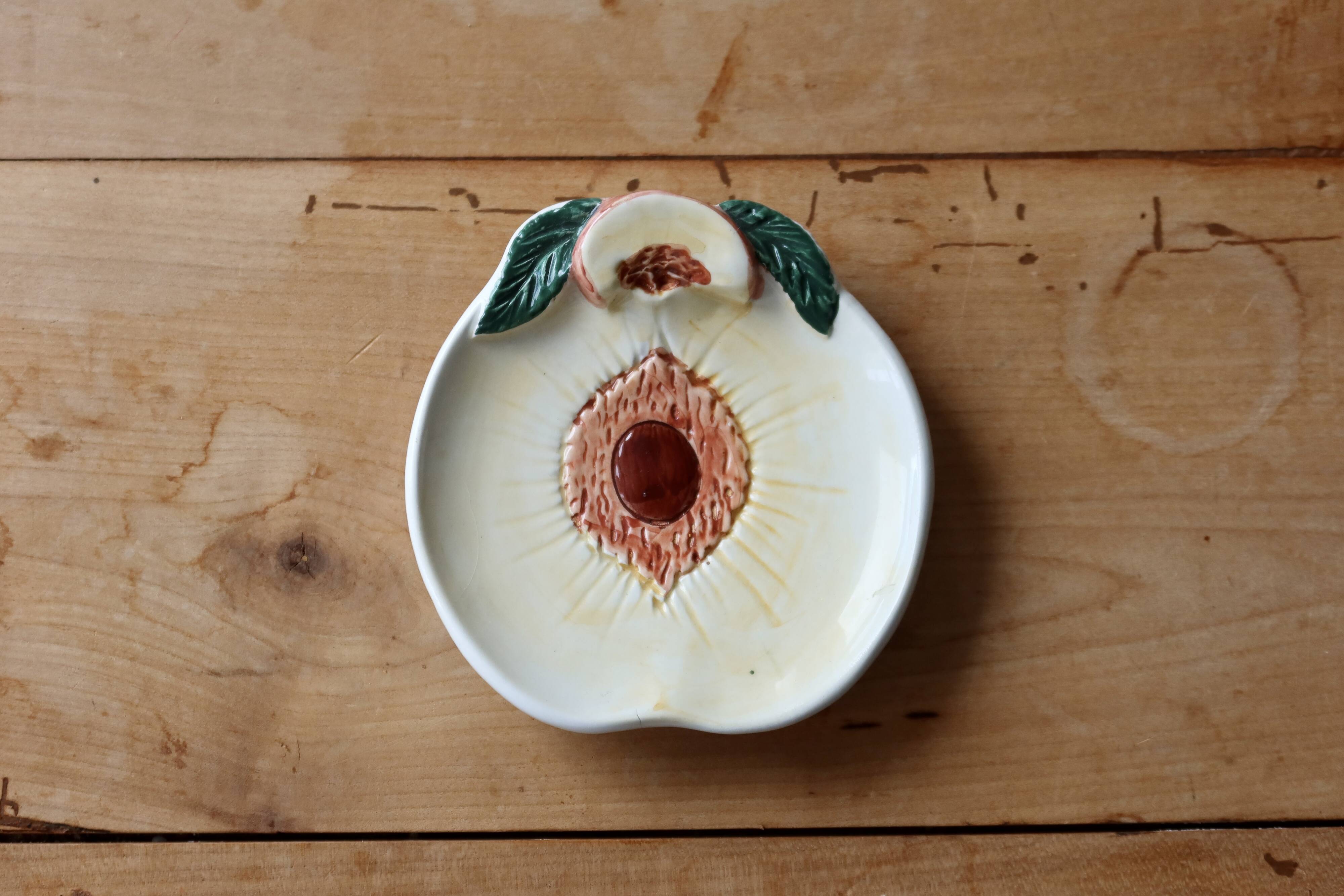 Small vintage barbotine bowl with peach-shaped pattern