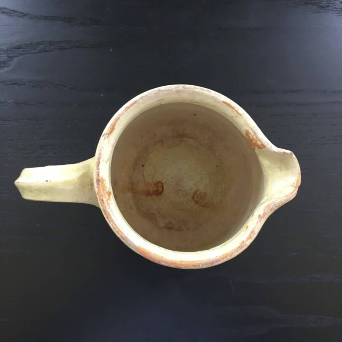 Antique pitcher of mixed earth