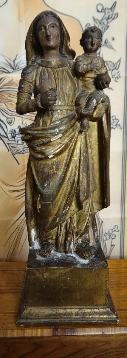 Ancient statue of the Virgin and Child in polychrome and gilded carved wood.
