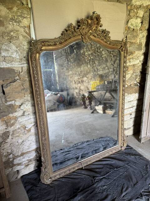 Large antique mirror in wood and gilded stucco.