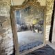Large antique mirror in wood and gilded stucco.