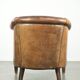 Vintage sheepskin club armchair finished with decorative nails