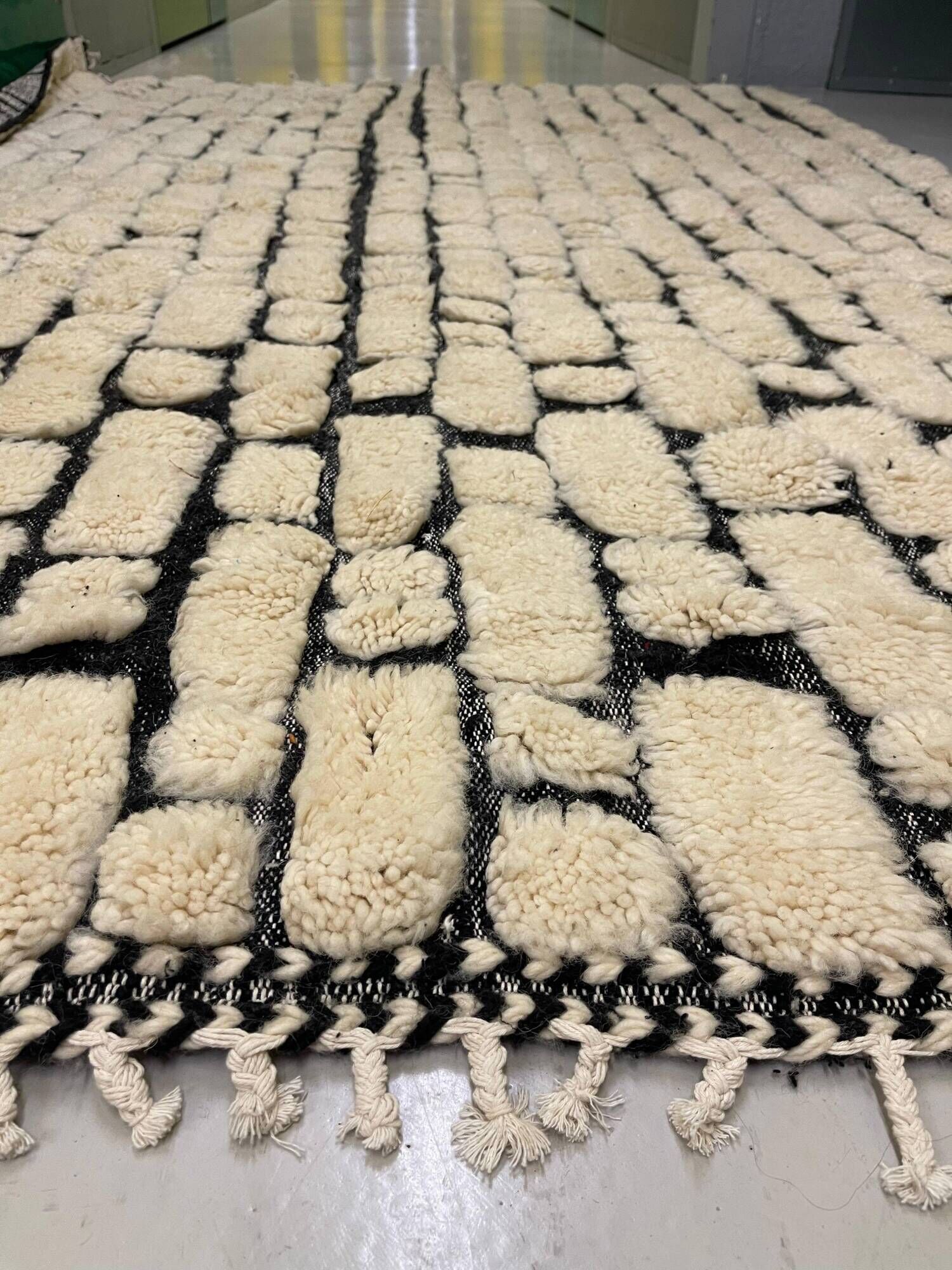 Large cream and black checked Berber rug, 280 × 200 cm.