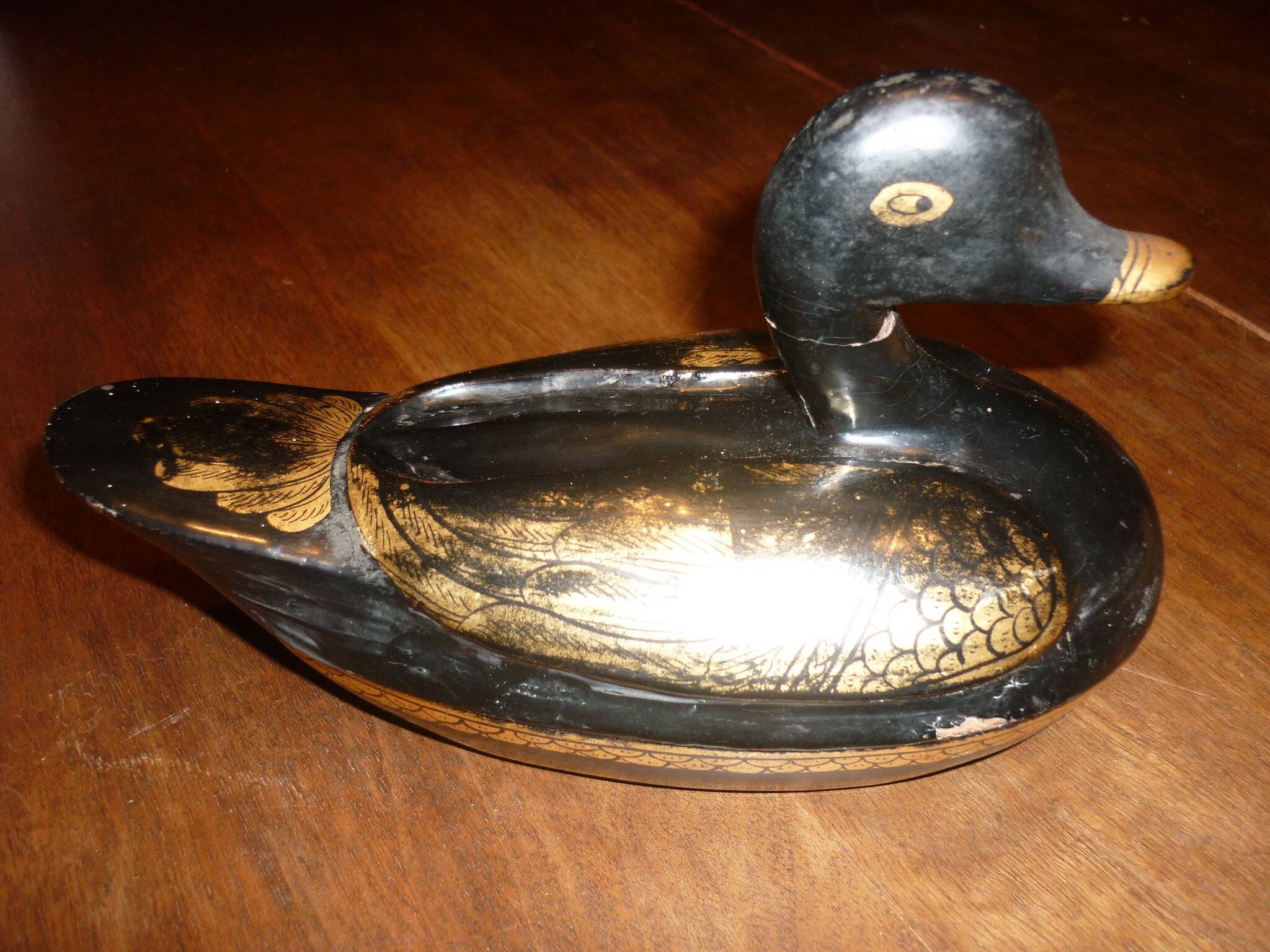 Black and gold wooden duck