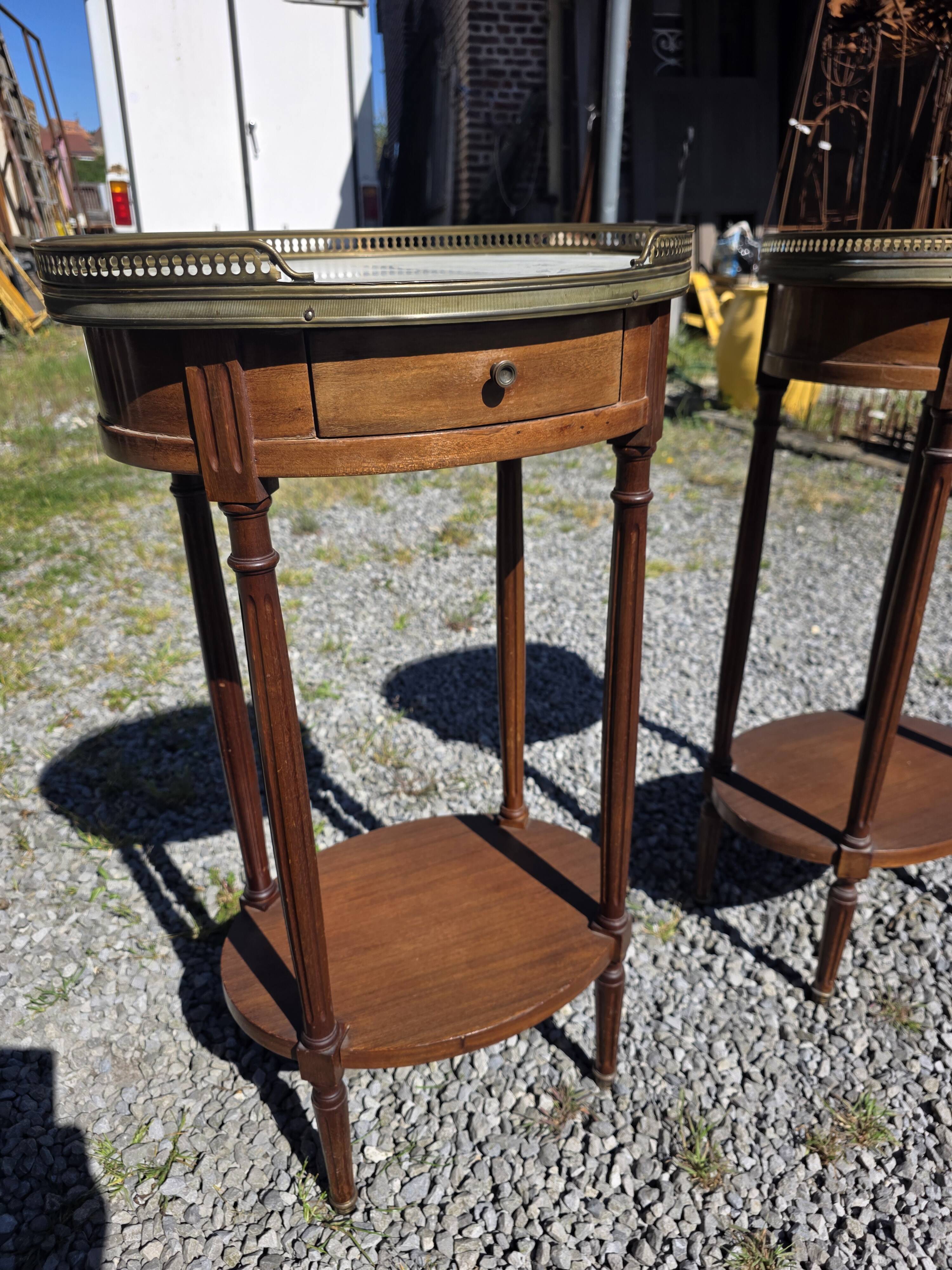 Pair of Louis XVI style bedside tables in mahogany, with marble tops.