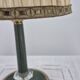 Brass table lamp with green patina and empire-style fabric shade.