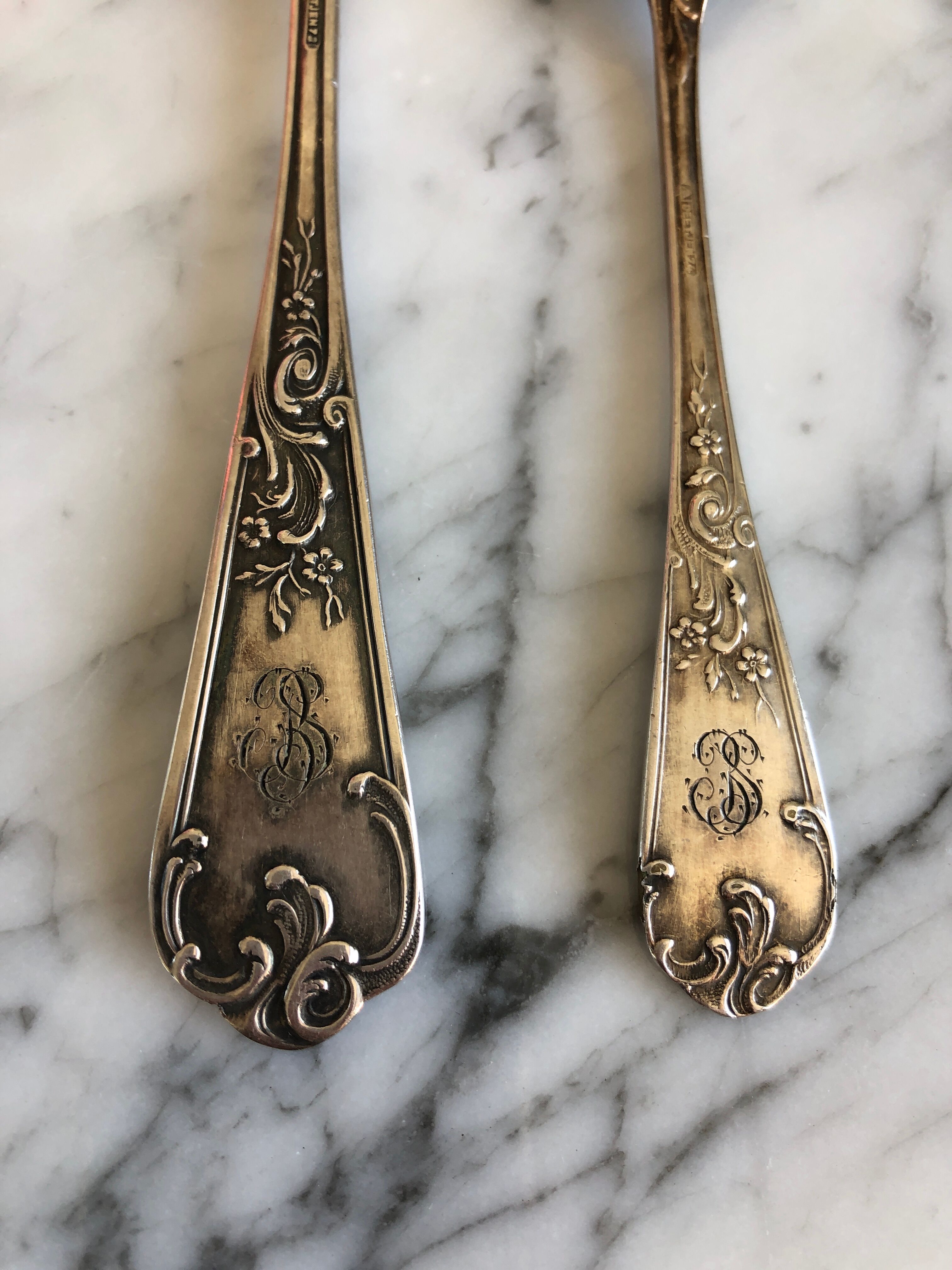 Duo of silver metal spoons