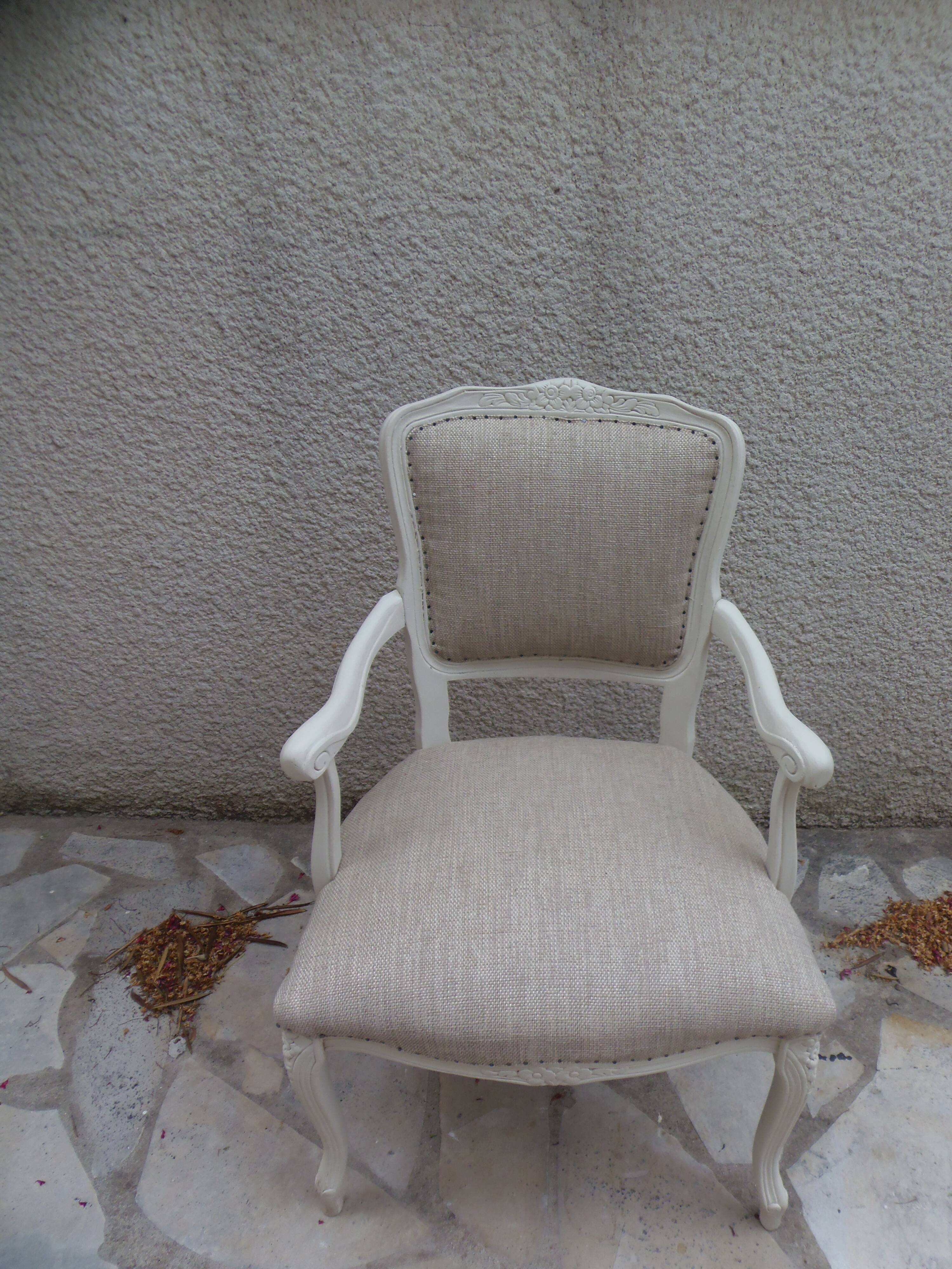 Louis XV style armchair in patinated beige, upholstered in beige fabric.
