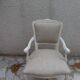 Louis XV style armchair in patinated beige, upholstered in beige fabric.