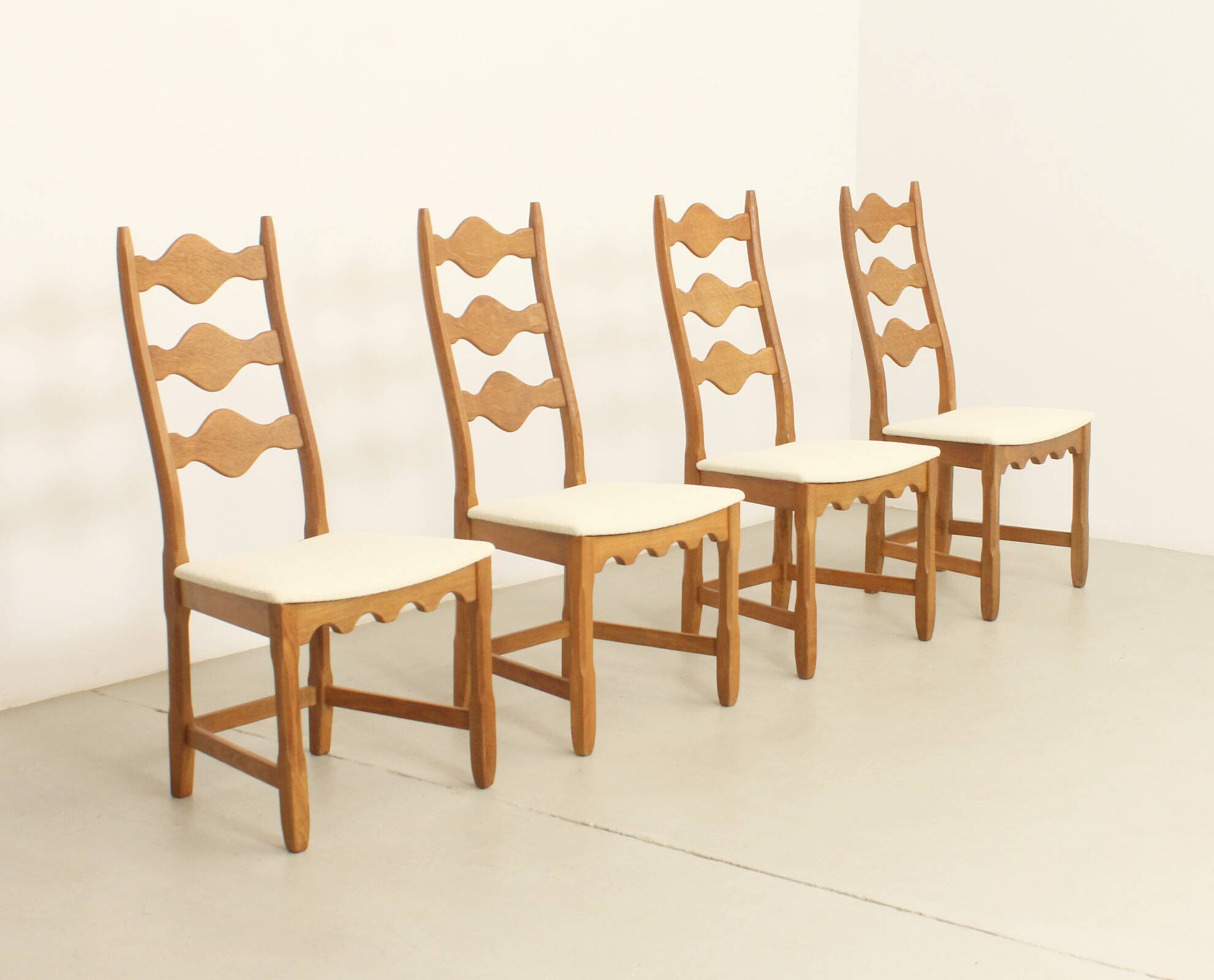 Four oak dining chairs by Henning Kjaernulf.