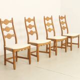 Four oak dining chairs by Henning Kjaernulf.