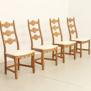 Four oak dining chairs by Henning Kjaernulf.