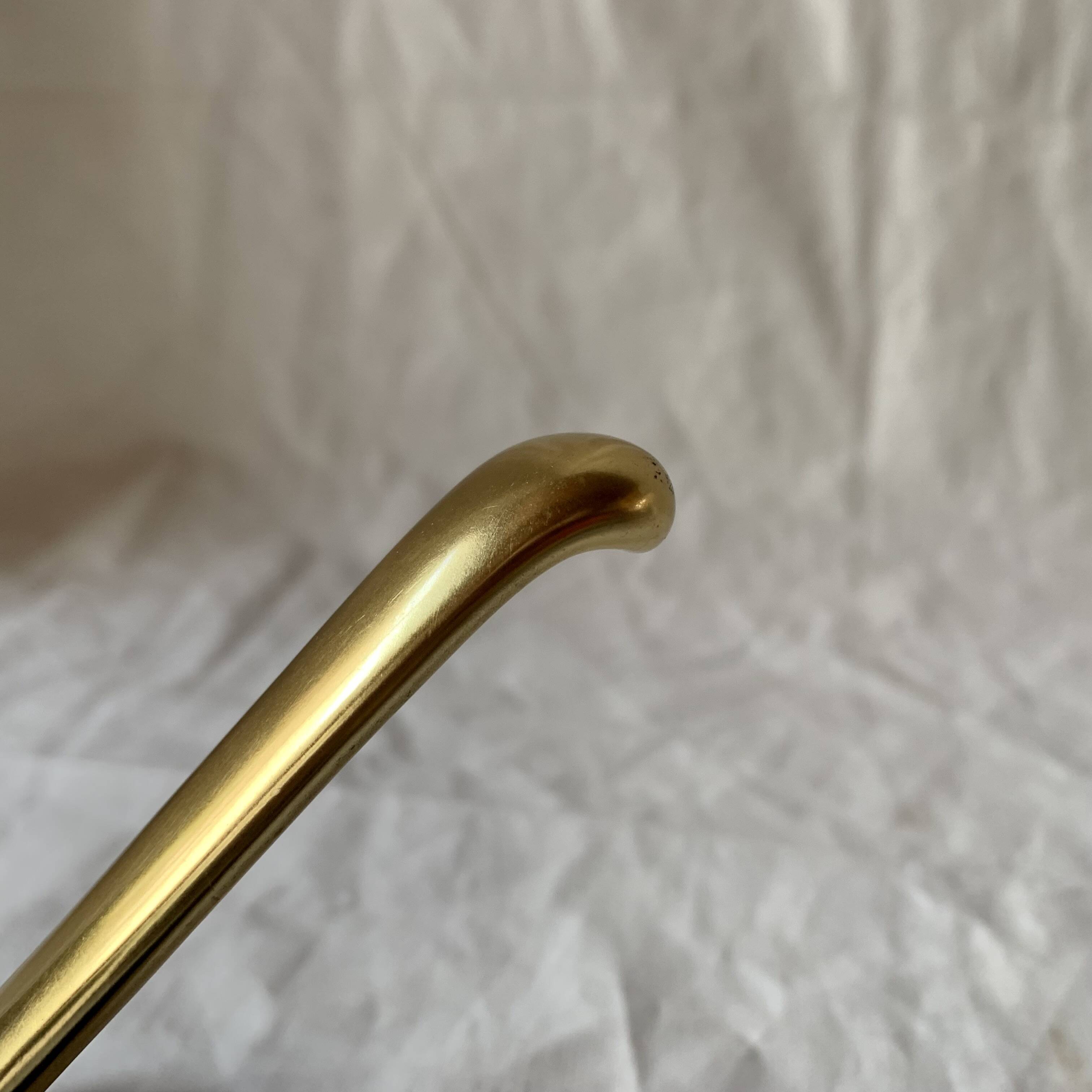 Vintage coat rack in lacquered metal with three golden aluminum hooks