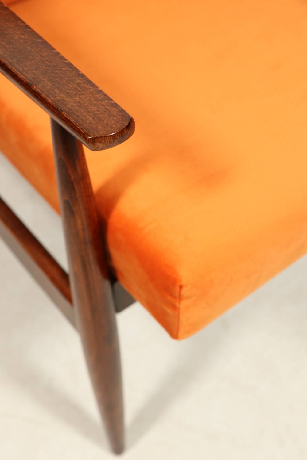 Modern armchair in orange papaya velvet with dark brown wood, 1970s Scandinavian style.