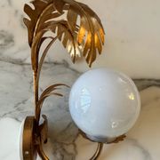 Pair of palm leaf wall lights in Hollywood Regency style with opaque globes by Hans Kögl, Germany, 1970s.