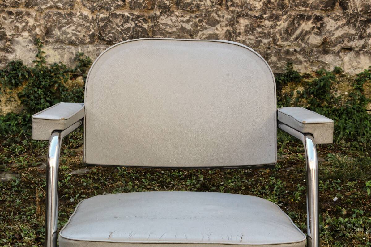 Set of 2 chairs and 1 armchair from the 70s in chrome metal and faux leather.