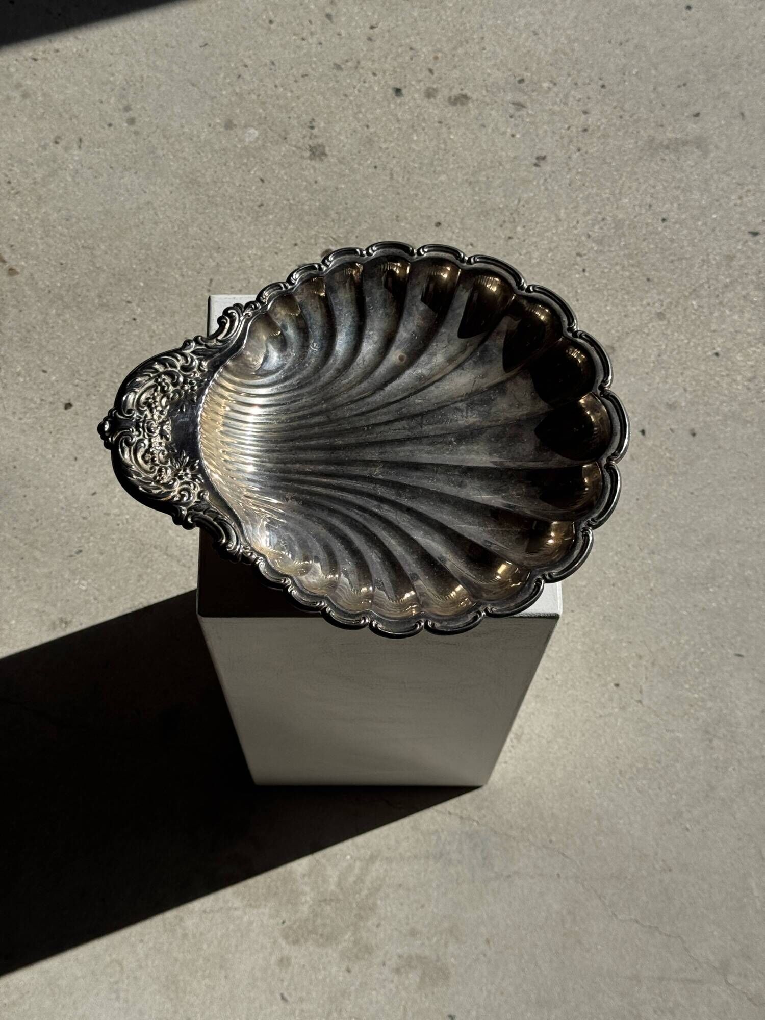 Large antique silver-plated bowl in the shape of a shell.