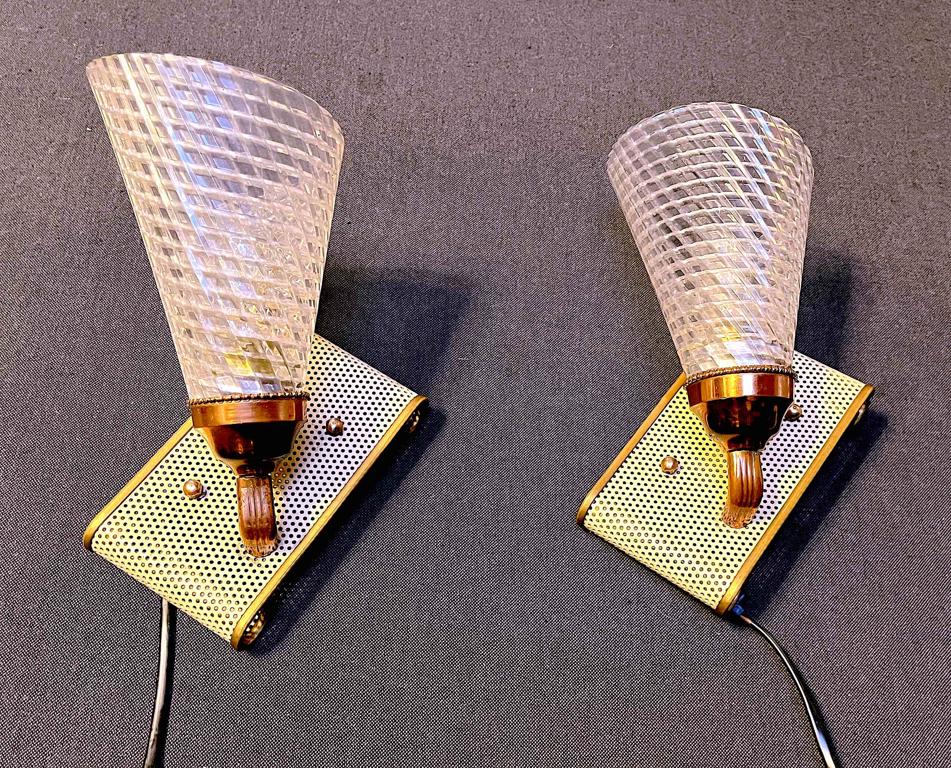 Pair of brass sconces, perforated metal and perhapx conical lampshade, France 50's
