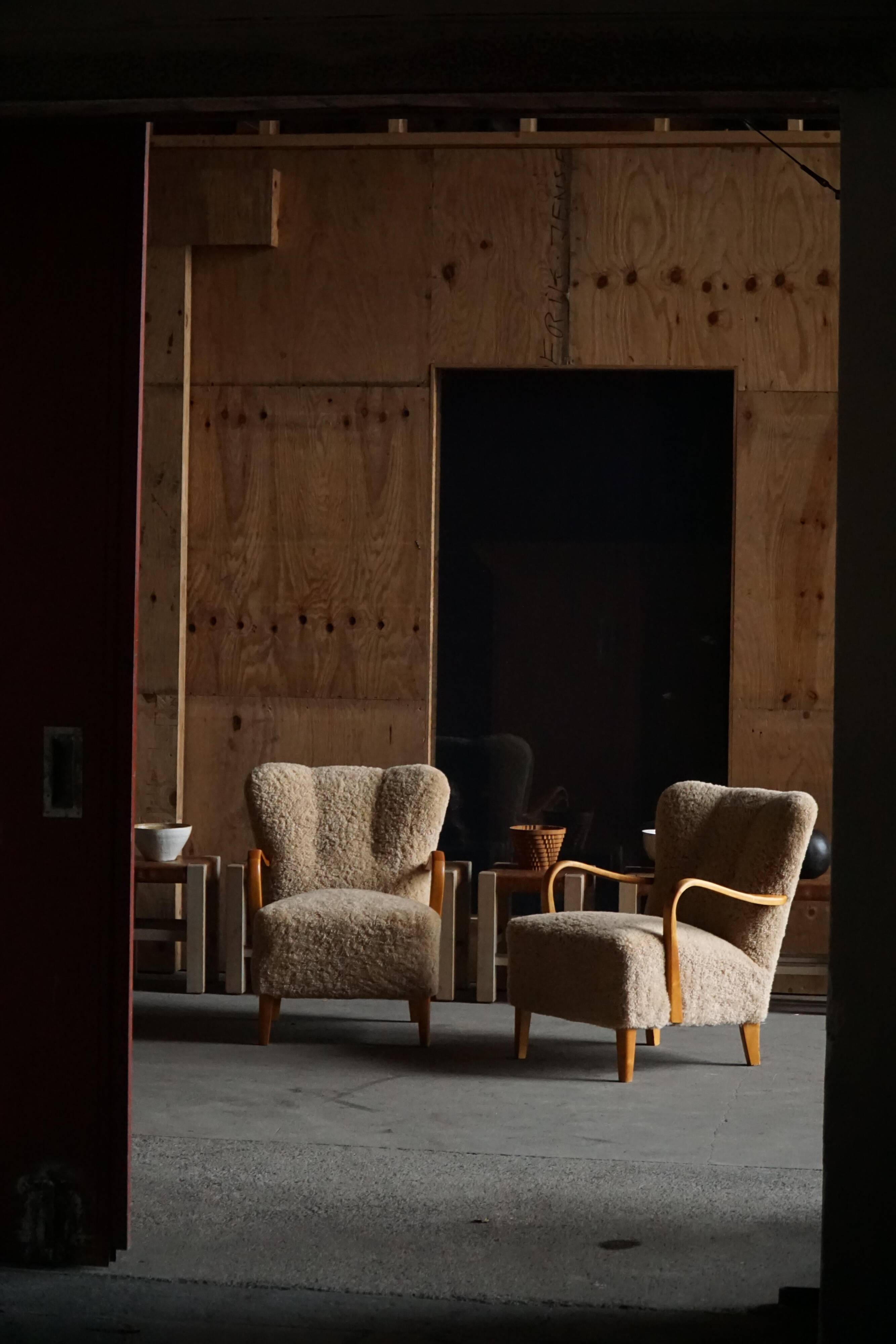 Pair of Mid Century Modern Swedish lounge chairs in birch and lamb's wool, 1960s.