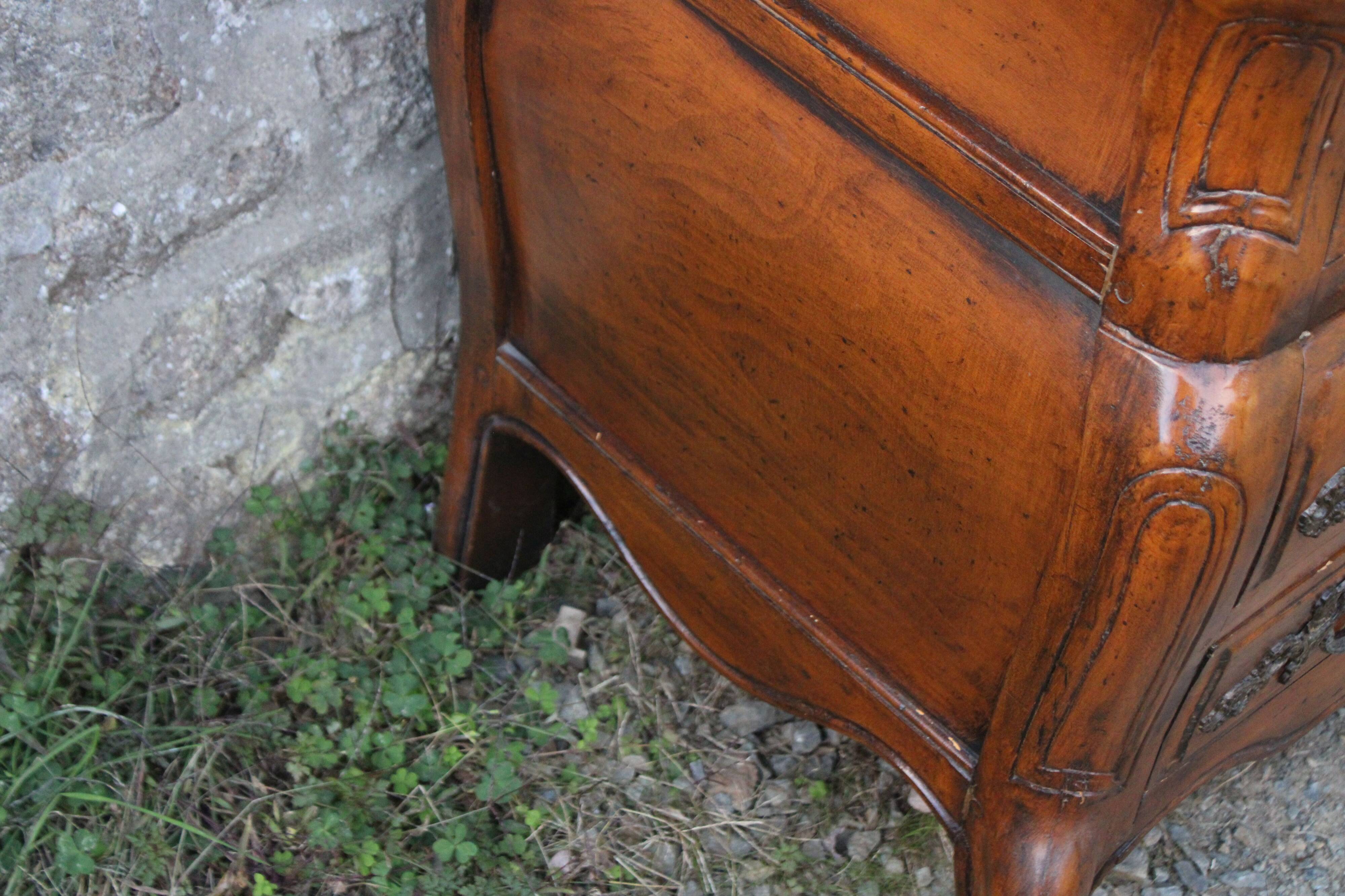 Curved Louis XV style chest of drawers known as a “tomb”