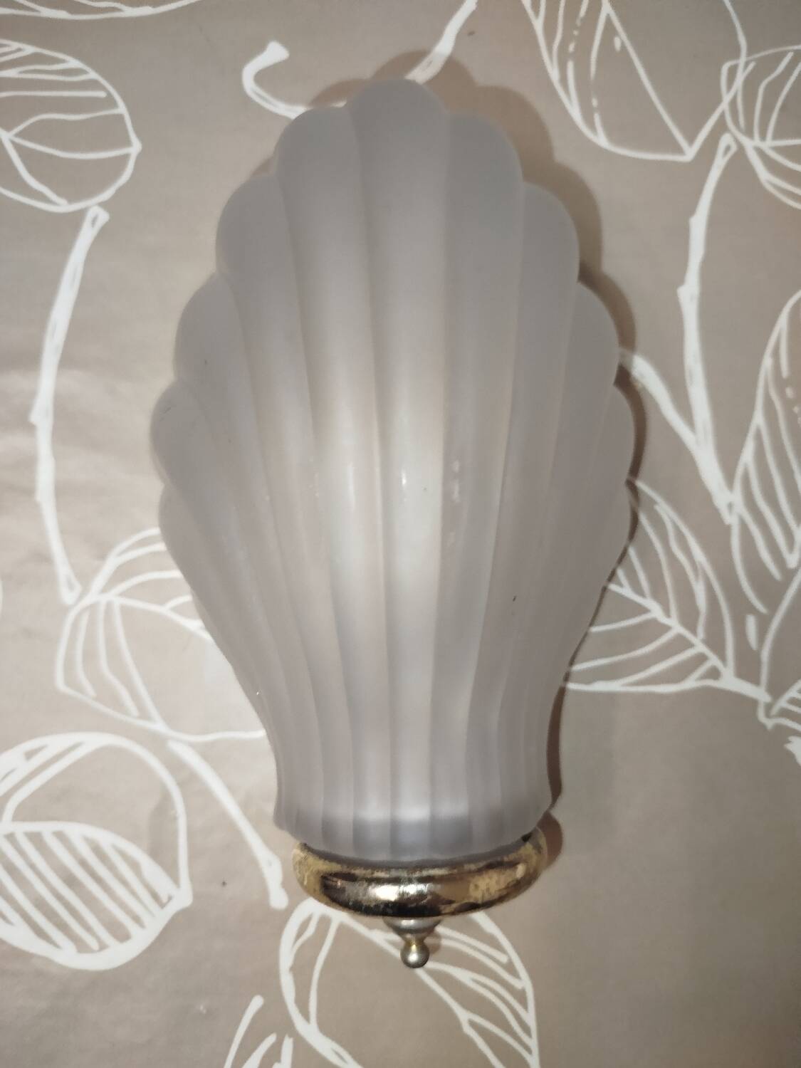 Art Deco wall sconces in frosted glass with a seashell design