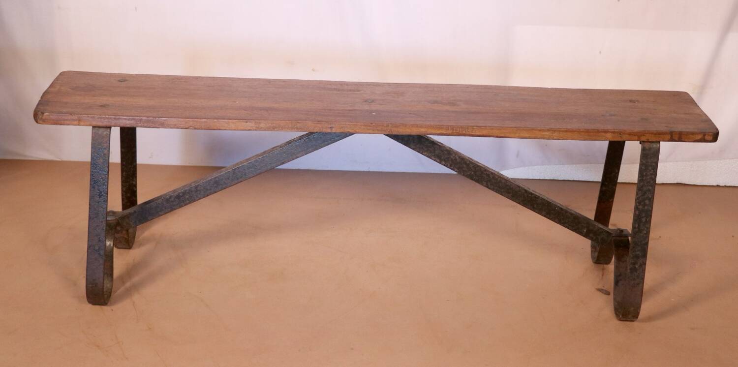 Old bench in Burmese teak with a wrought iron base.
