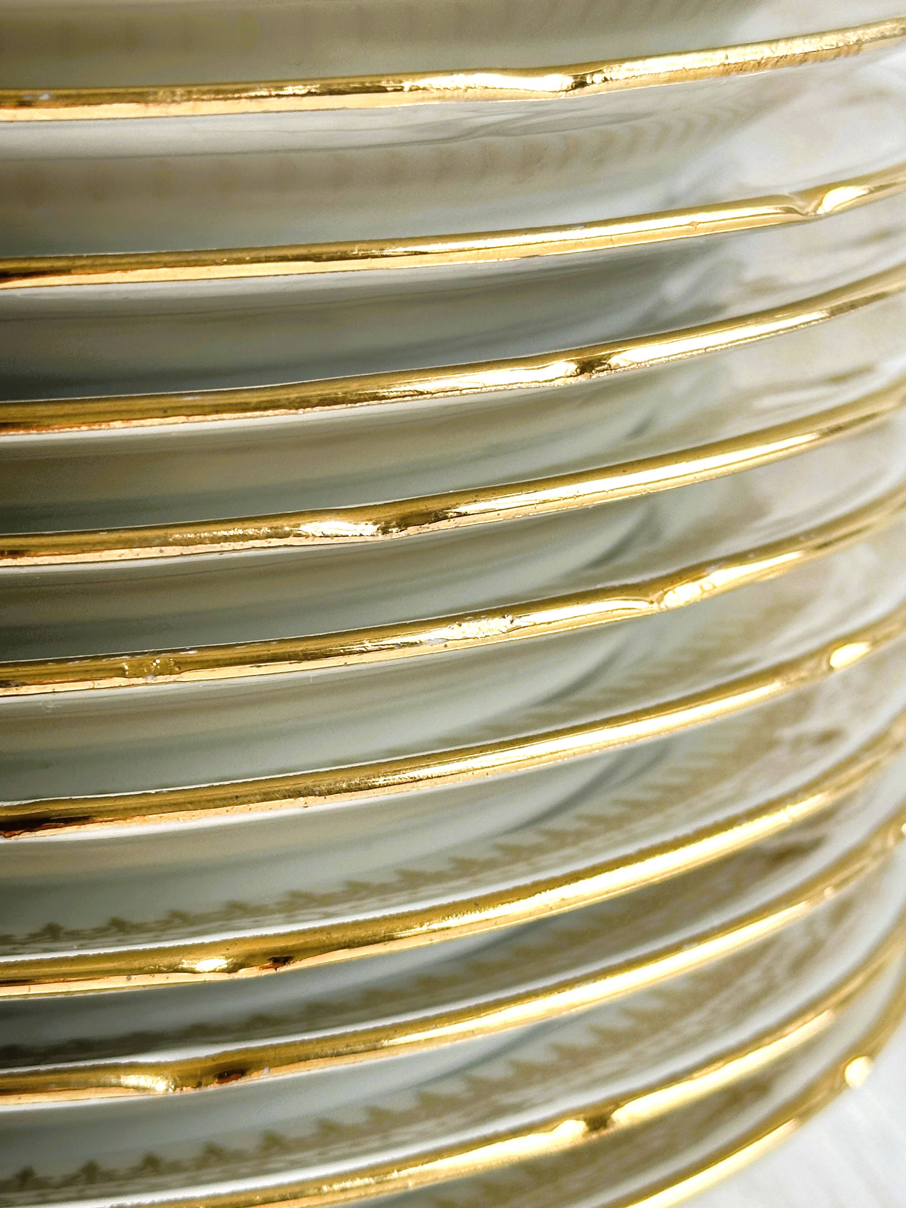 12 Limoges porcelain dessert plates, gold decoration.